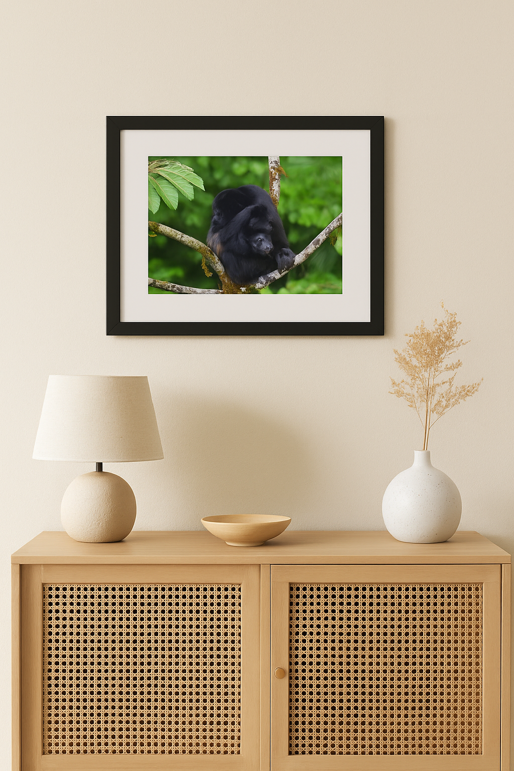 Framed picture of a black bear on a wall above a wooden cabinet with decorative items.
