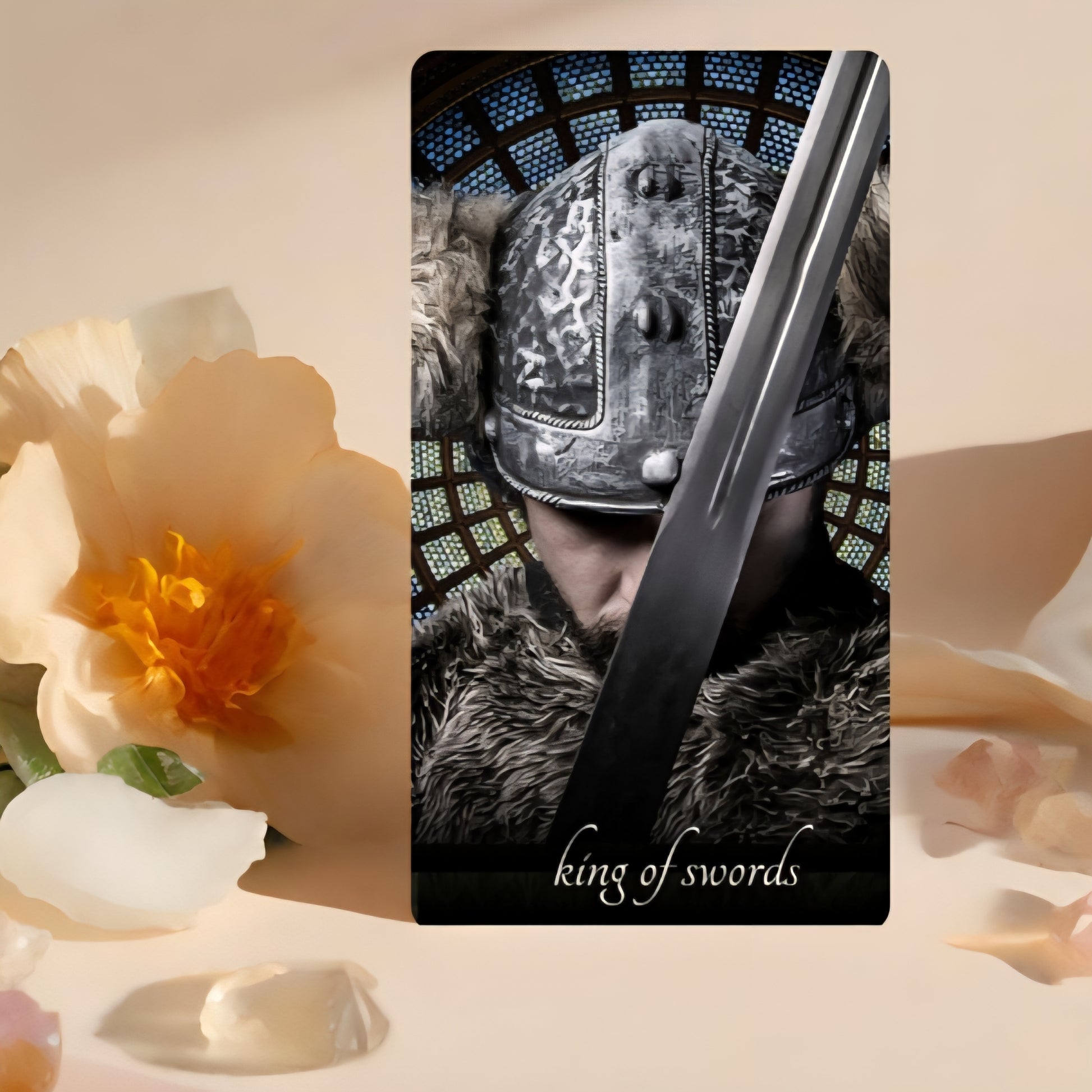 Card featuring a warrior with a sword labeled 'King of Swords' on a decorative background with flowers.