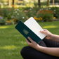Rainbow notebook held outdoors in park