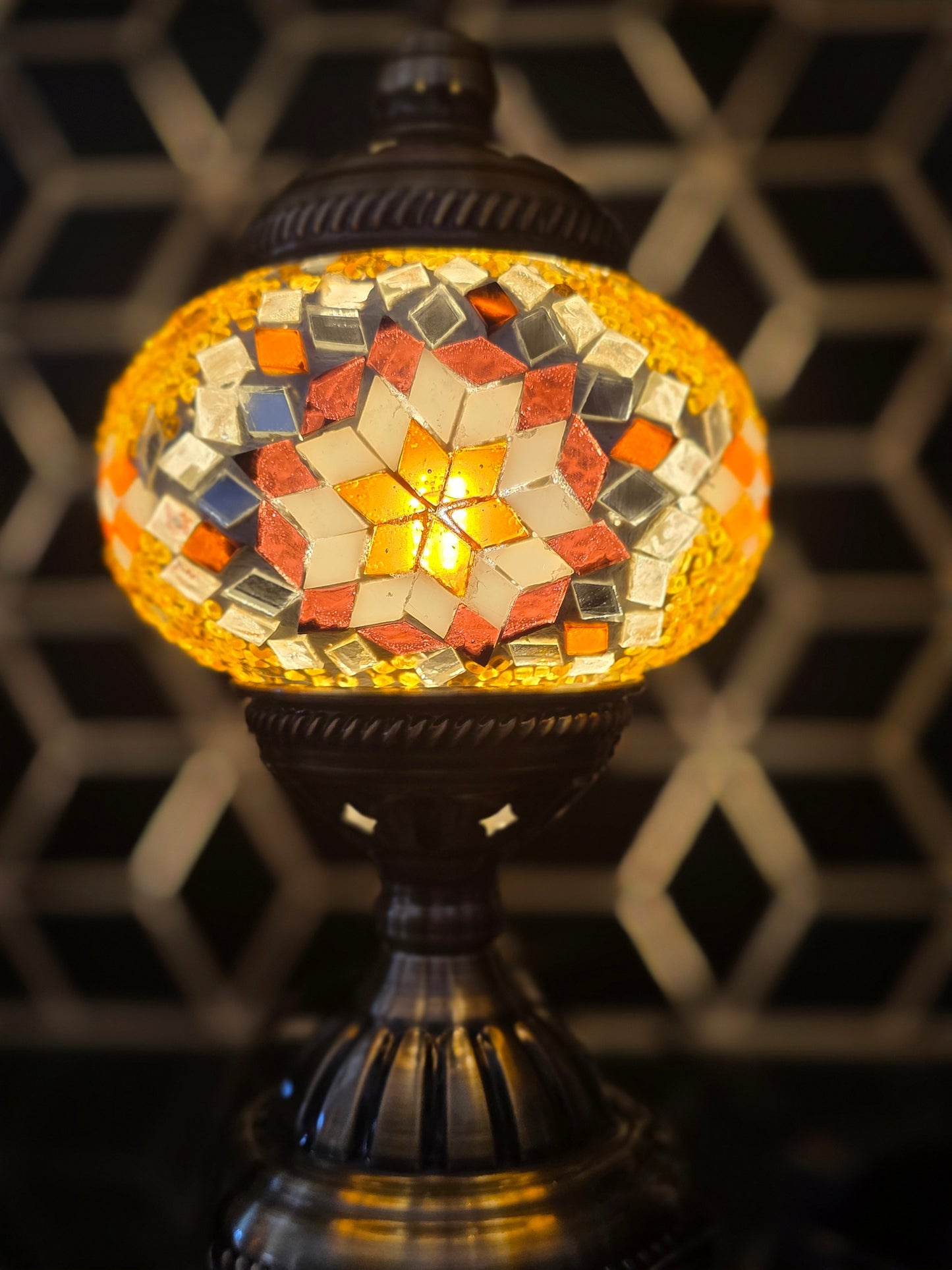 Golden Star Turkish Mosaic Lamp illuminating a reading nook, creating a warm and inviting atmosphere.