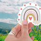 Heartfelt Rainbow Sticker against a colorful background, demonstrating its waterproof and durable design, perfect for everyday use.